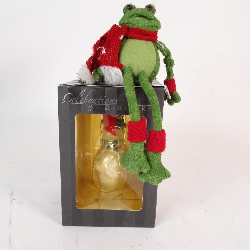 Holiday Christmas Decor Lot: Charming and eye-catching Christmas decor set. Includes a festive plush frog with red scarf, Santa hat, and long dangling legs?perfect for a shelf, mantel, or chair?and a glittered glass snowman ornam