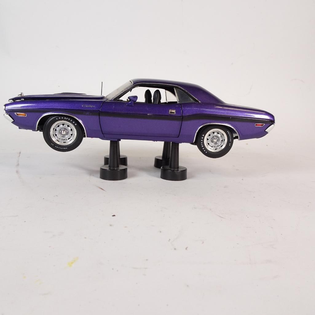 Vintage 1970 Dodge Challenger R/T 1:18 Diecast Model: Classic 1970 Dodge Challenger R/T diecast model in 1:18 scale, finished in a striking deep purple with black interior. This iconic American muscle car features authentic body lines, detailed