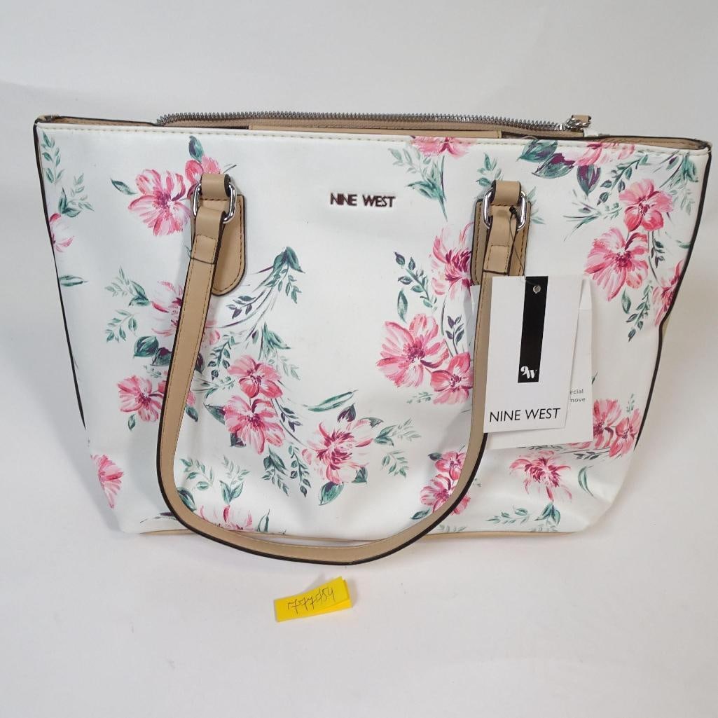 Nine West Floral Print Tote Bag: Elegant Nine West tote bag featuring a soft white base with a pink floral print. Designed with comfortable shoulder straps, a top zip closure, and a spacious, fully lined interior with an inner zip po