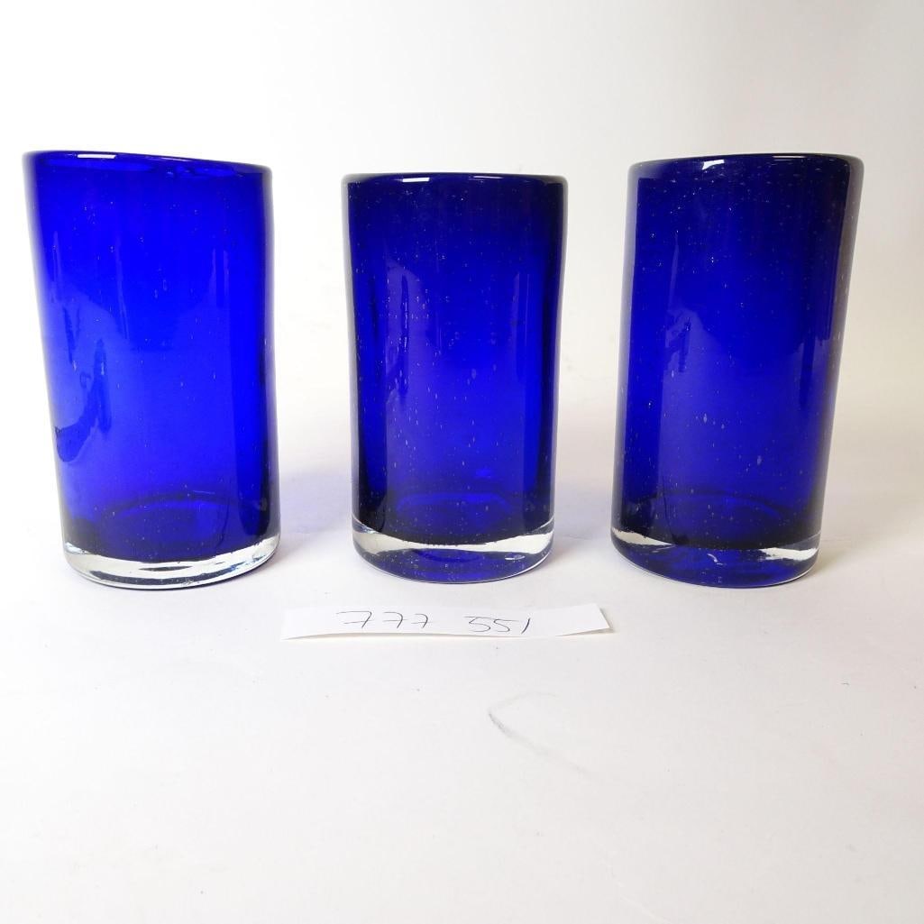 Cobalt Blue Glass Tumblers - Set of 3: Set of three cobalt blue glass tumblers with a thick, clear base. Approx. 5.5 inches tall. Elegant, minimalist style-perfect for water, cocktails, or everyday use. Great color accent for any table or