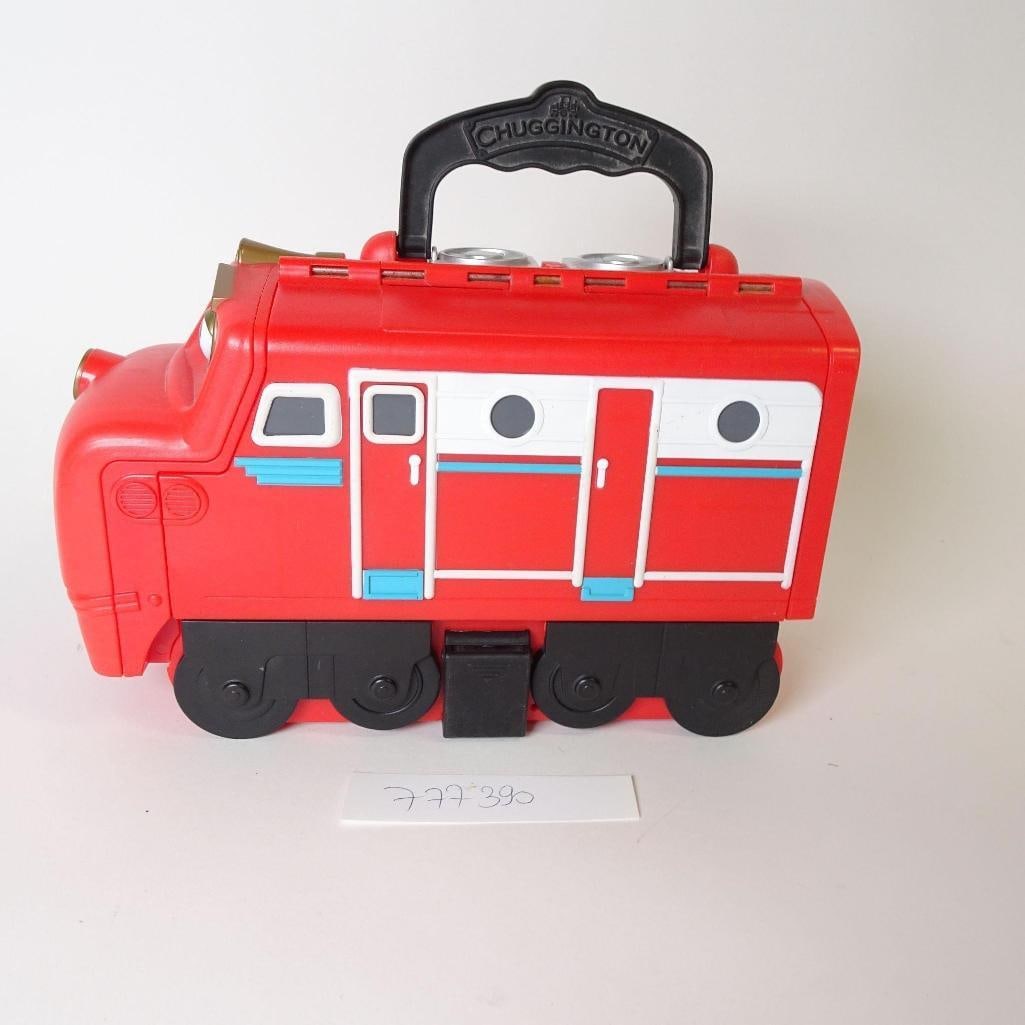 Chuggington Red Train Carry Case: Bright red Chuggington train-shaped carry case, perfect for young fans of the popular animated series. The train opens up to store small toys, figures, or accessories and features a sturdy built-in ha