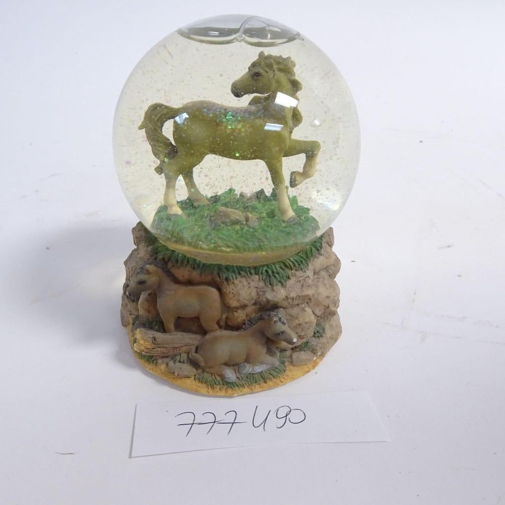 Horse Snow Globe Music Box: Decorative horse-themed snow globe music box featuring a standing horse inside the glass globe and a detailed base with two foals set in a rocky landscape. Produced by San Francisco Music Box Company.