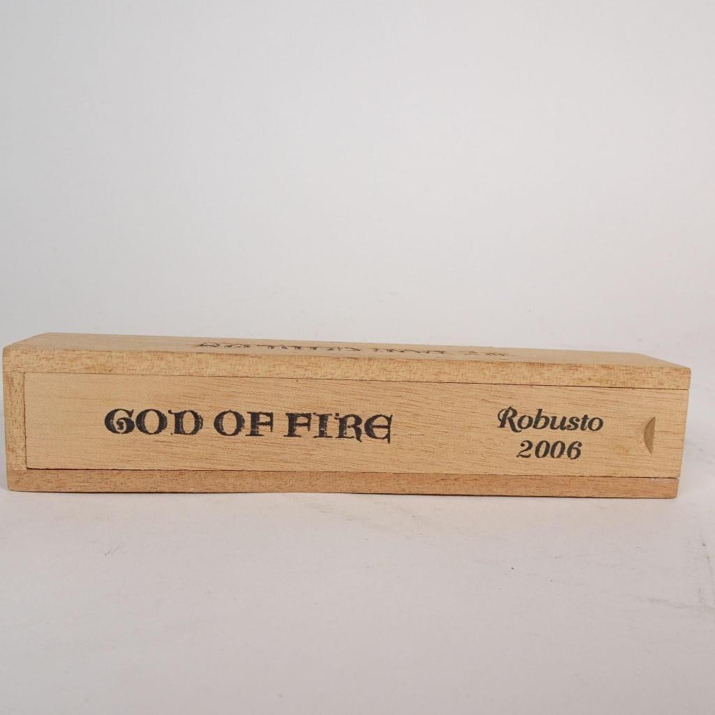 God of Fire Robusto 2006 Sliding Wood Cigar Box: God of Fire “Robusto 2006” sliding wooden cigar presentation box. This is an original empty wooden cigar box designed for the God of Fire Robusto release. The box features a sliding drawer-sty