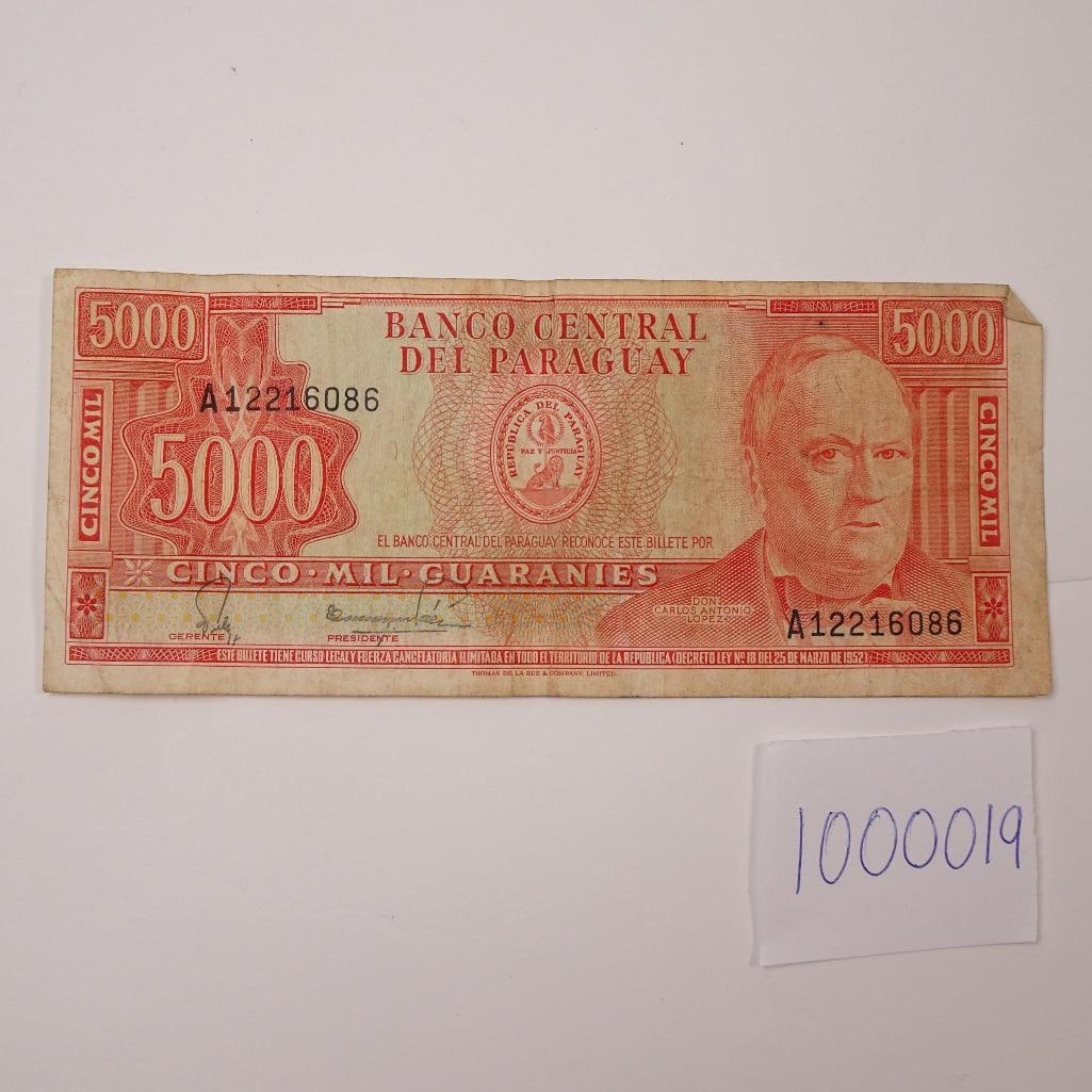 Paraguay 5000 Guranies 1982-1984:: Vintage Paraguayan 5000 Guaranies note issued in 1982. A collectible piece showcasing historic design and national heritage. Condition varies; please refer to photos for specific issues and details.