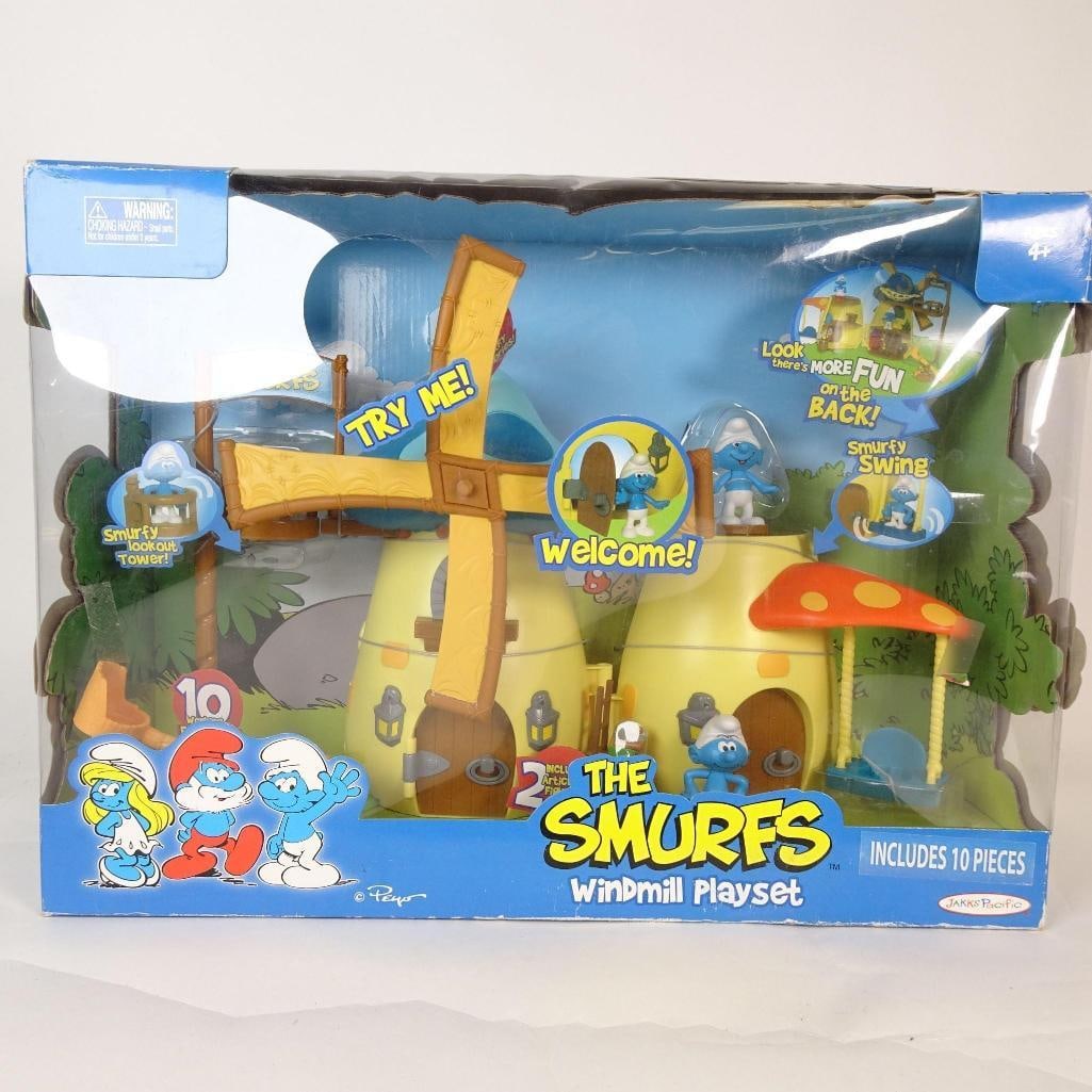 The Smurfs Vintage Windmill Playset +Vehicle: Both items are presented in their original packaging. Boxes show visible shelf wear, creases, and handling marks, consistent with age, but contents appear complete and display well. A fantastic