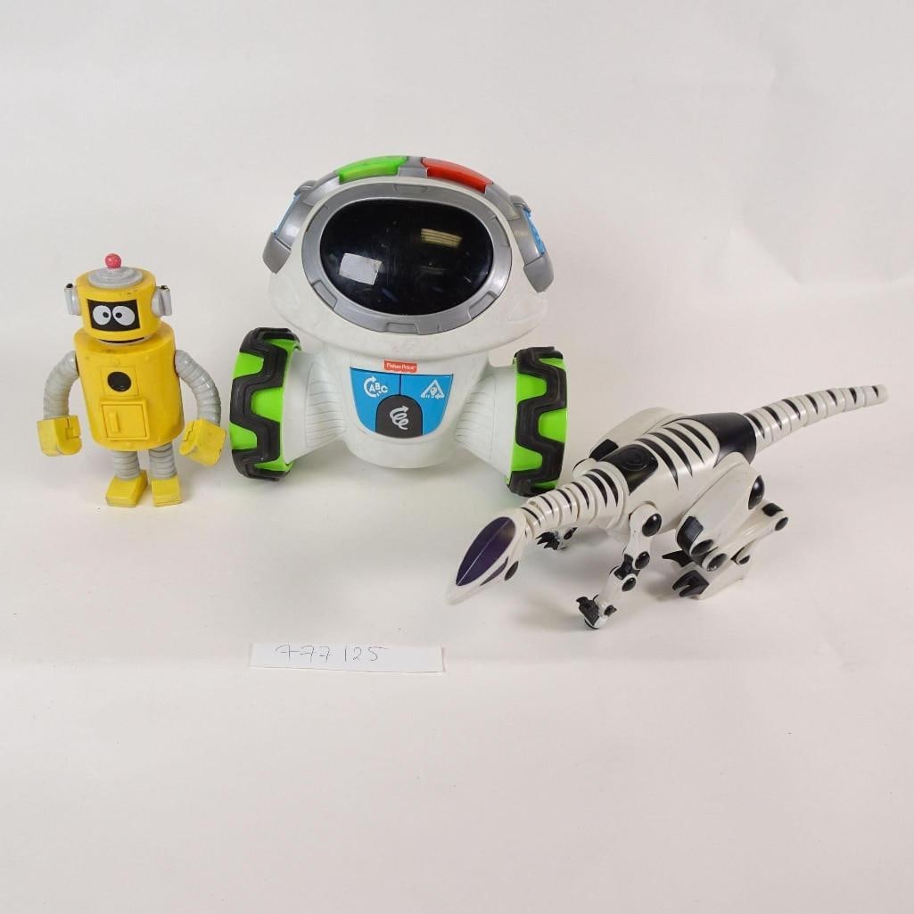 Fisher-Price Electronic Robot Toy Lot: Group lot of children's toys including a Fisher-Price electronic learning robot and two additional robot-themed toys. The lot features a large interactive Fisher-Price robot with wheels, a robotic din