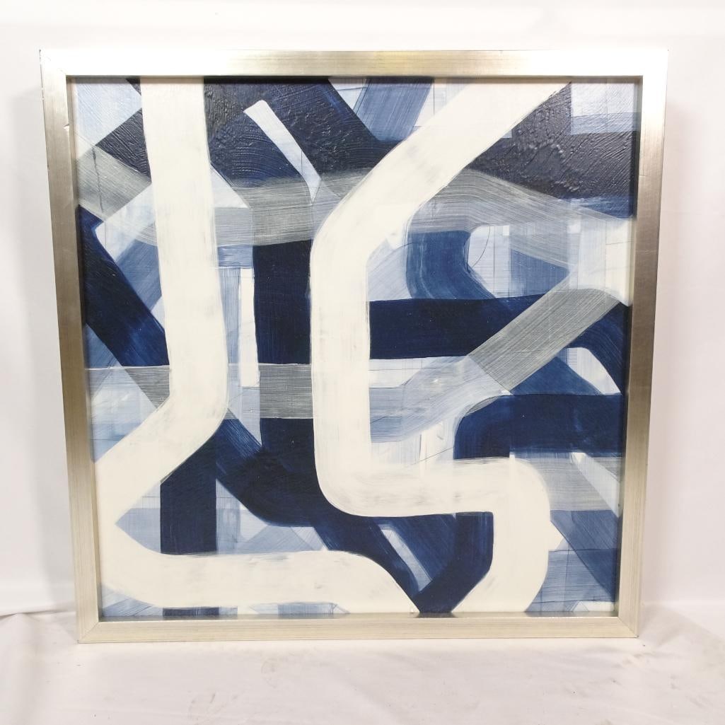 Abstract Blue & White Framed Canvas: Modern abstract canvas featuring bold, sweeping brushstrokes in shades of blue, white, and gray. The artwork has a dynamic, layered composition that fits well with contemporary, minimalist, or coastal