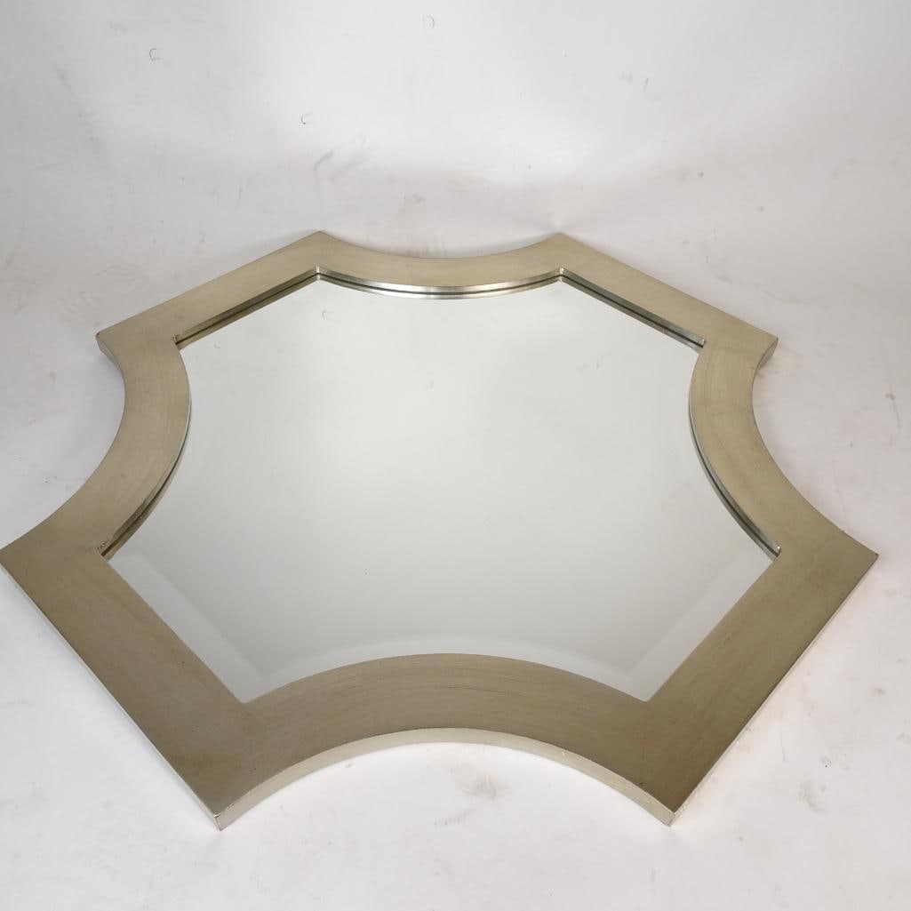 Modern Geometric Wall Mirror Silver Frame: Stylish modern wall mirror featuring a unique geometric shape and brushed silver-tone frame. This decorative accent mirror adds a contemporary touch to entryways, bedrooms, bathrooms, or living spaces
