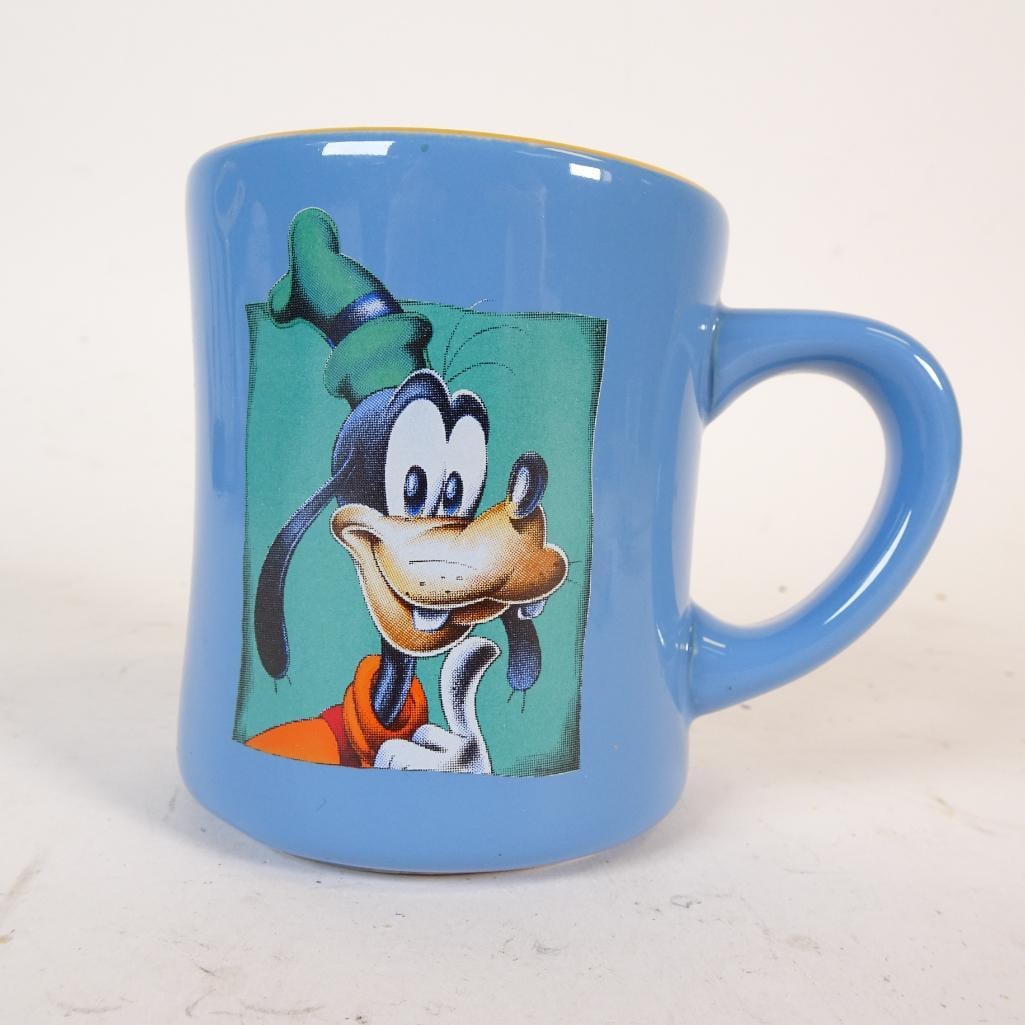 Vintage Disney Goofy Ceramic Coffee Mug: Original vintage Disney Goofy ceramic coffee mug featuring a colorful character graphic on a light blue background. The mug is marked ?Disney - Made in Thailand? on the base and dates to the 1990s-ear