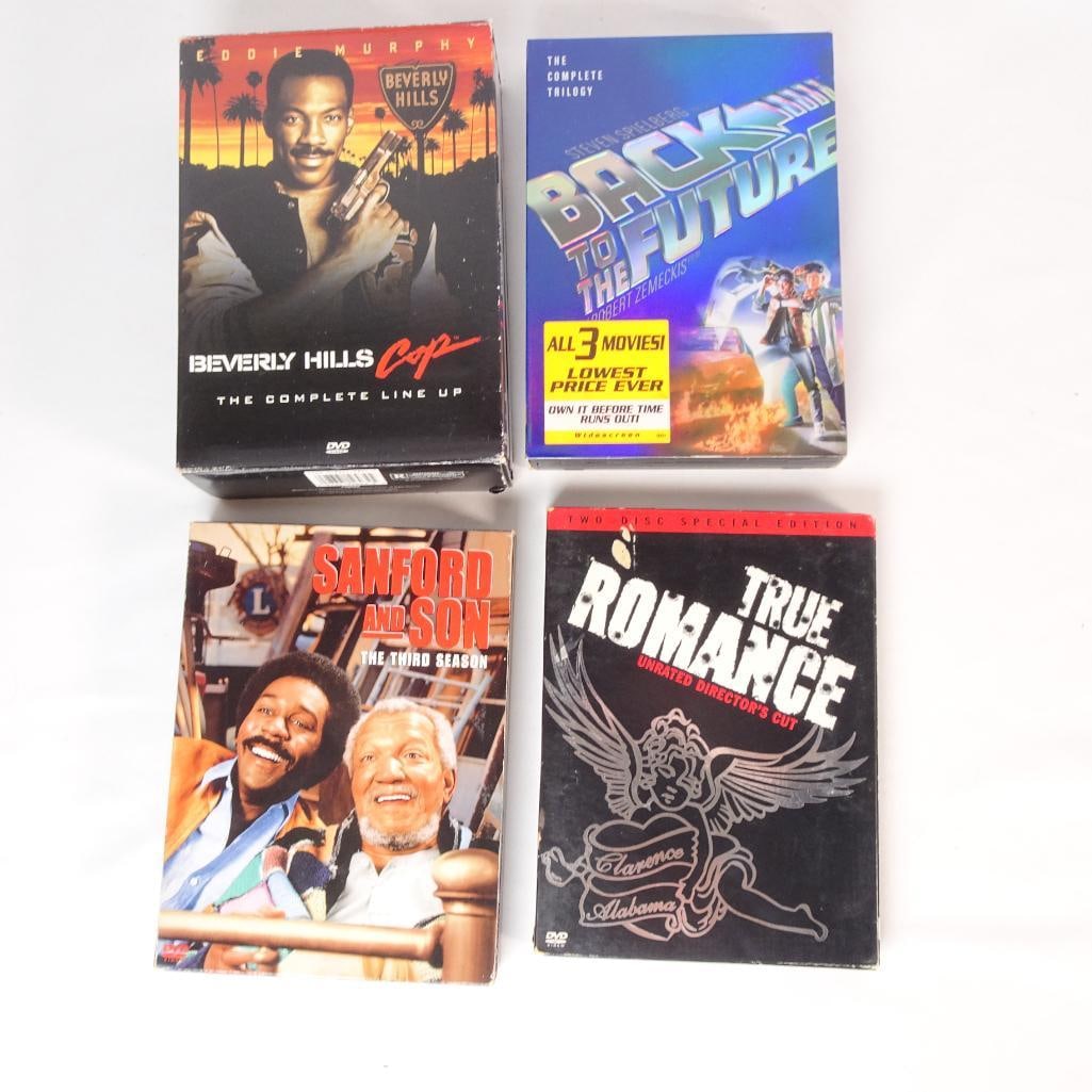 DVD Movie Lot - Back to the Future Trilogy, Beverly Hills Cop Box Set, True Romance, Sanford & Son S: Mixed DVD movie and TV collection featuring classic action, comedy, and cult films. All DVDs come in their original cases or box sets. Discs are included as shown in the photos. Pre-owned condition wi