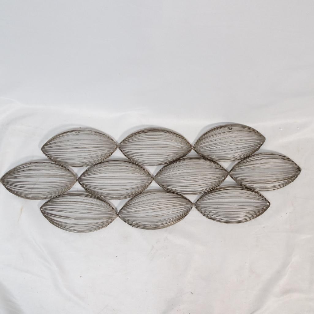 Mid Century Modern Metal Wall Art: Elegant mid-century modern style metal wall decor featuring a series of sculptural oval leaf shaped wire elements arranged in a geometric pattern. The open wire design creates a light, airy look and a