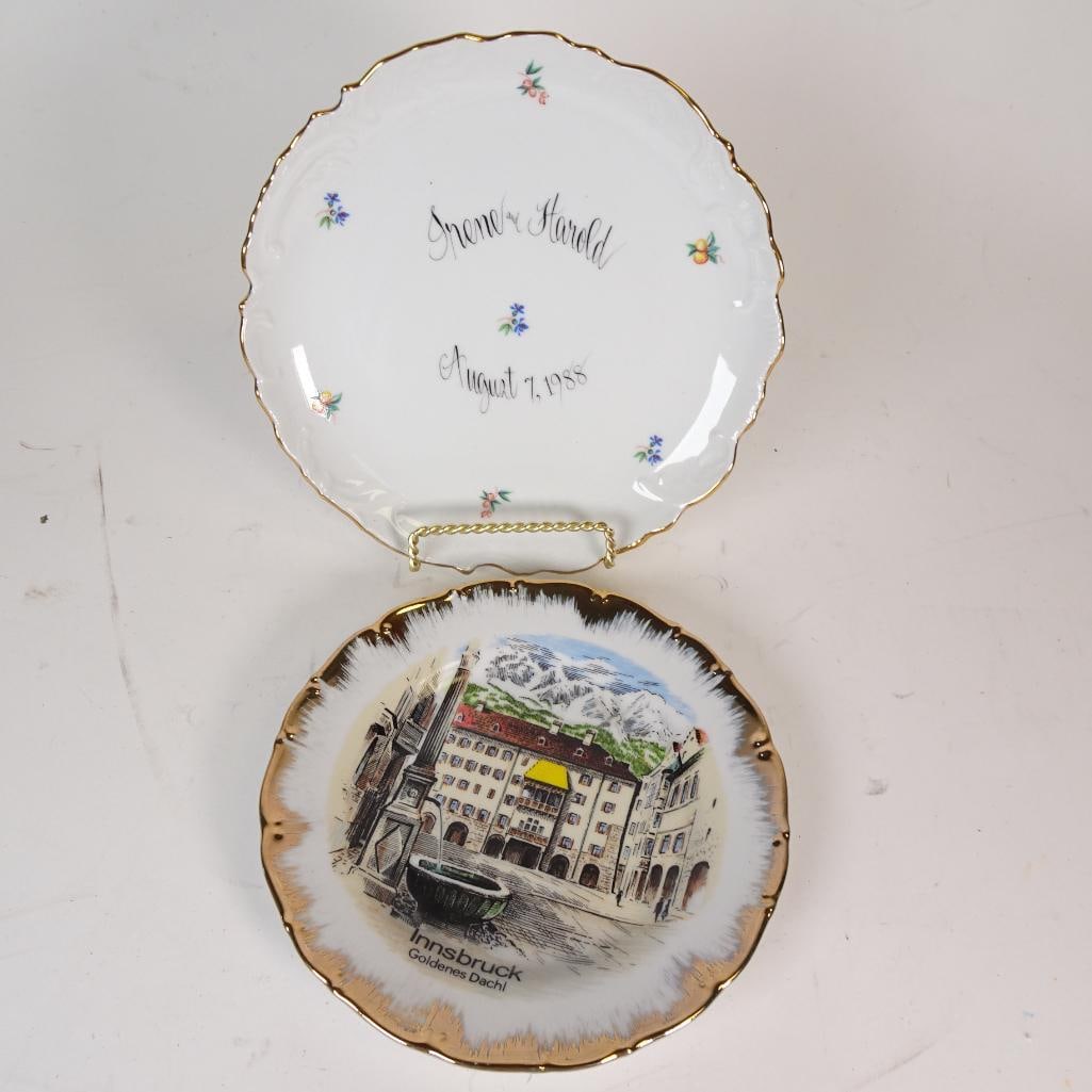 Lot of 2 Vintage Collector Plates: Set of two beautiful vintage souvenir collector plates featuring the famous Golden Roof (Goldenes Dachl) in Innsbruck, Austria. Both plates have elegant scalloped edges with rich gold trim and a detai