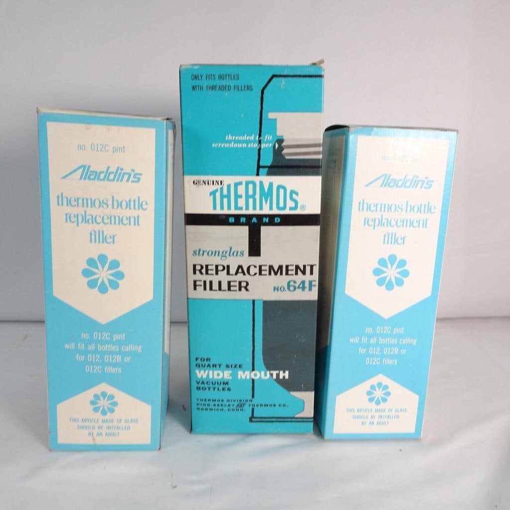 Vintage Thermos / Aladdin replacement filler (glass liner): Vintage lot of glass thermos replacement fillers including Thermos Brand Stronglas and Aladdin models. Condition: Glass liners appear unused (new old stock) Boxes show age and shelf wear One stopper s