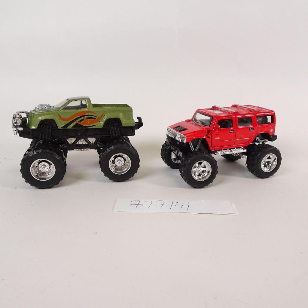 Lot of 2 Monster Truck Toy Vehicles: Lot of two monster truck style toy vehicles. Includes one red SUV-style truck and one green pickup truck, both with oversized rubber tires and raised suspension. Mixed materials (die-cast metal and pl