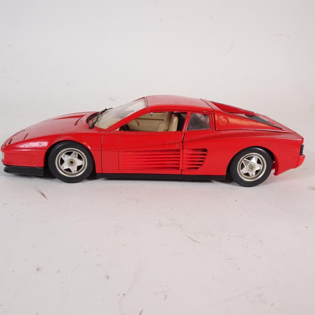 Vintage Ferrari Testarossa 1:18 Diecast Model Car: Authentic vintage Ferrari Testarossa diecast model car in 1:18 scale, produced by Bburago and made in Italy. Finished in classic red with a detailed beige interior. The model features opening doors, r