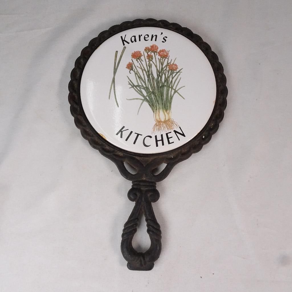 Vintage Cast Iron Ceramic Kitchen Trivet Wall Decor ?Karen?s Kitchen? Floral Hot Plate: Charming vintage-style cast iron and ceramic kitchen trivet featuring floral artwork and the phrase Karens Kitchen. The piece has a decorative ornate cast iron frame with attached handle and white cer