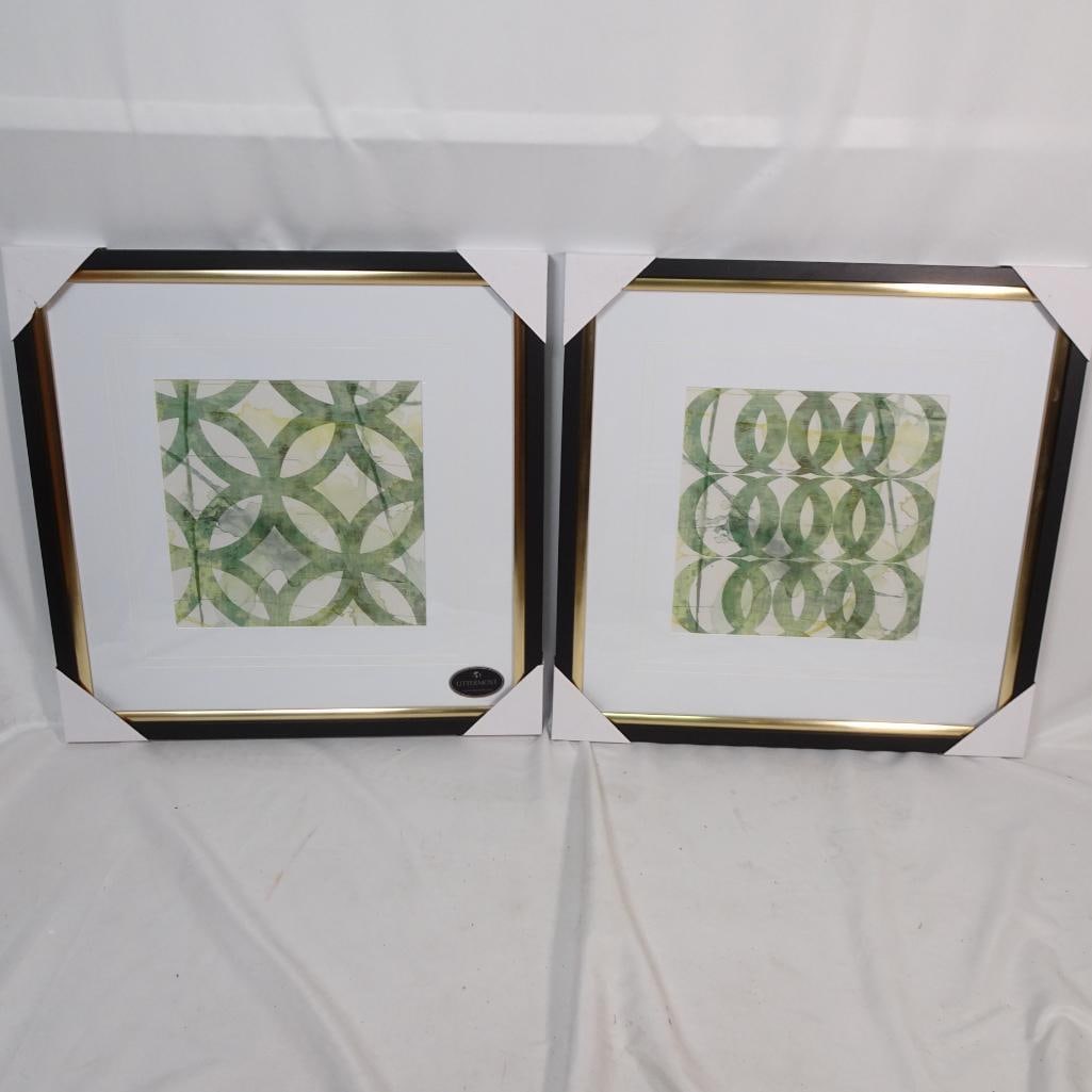Uttermost Set of 2 Framed Abstract Geometric Prints: Elegant set of two framed abstract geometric prints by Uttermost, featuring modern circular pattern designs in soft green, sage, and light yellow tones. The artwork is beautifully presented in black