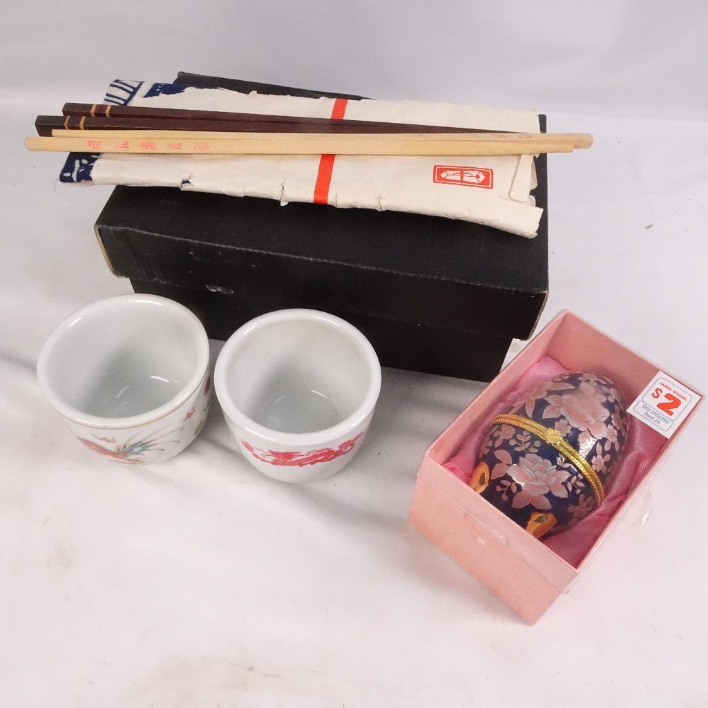 Vintage Japanese Sake Set Chopsticks Dragon Cups Egg Trinket Box Asian Decor Lot: Unique mixed Asian-inspired decor and dining lot featuring a Japanese sake set, chopsticks, porcelain cups, and decorative trinket box. Great for collectors, Asian decor displays, or vintage kitchen/b