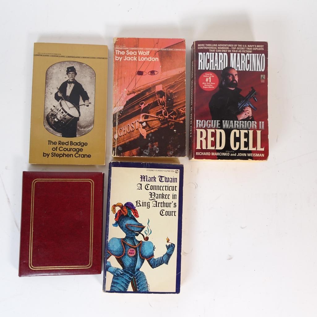 Classic and Military Paperback Book Lot: Mixed lot of classic literature and military fiction paperbacks including Mark Twain, Jack London, Stephen Crane, and Richard Marcinko, plus a vintage red book cover. These editions show age and readi
