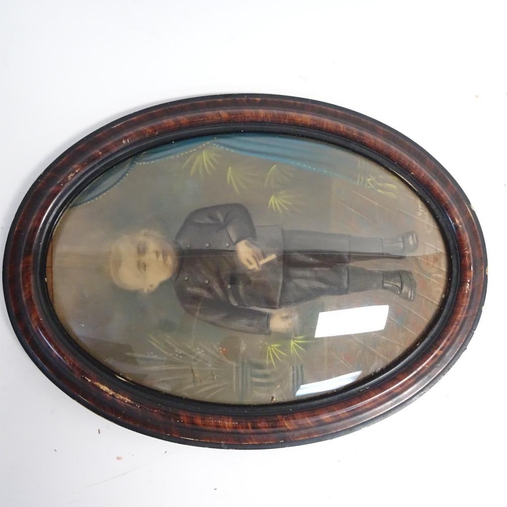 Antique Oval Framed Portrait of a Young Boy - 19th / Early 20th Century: Original antique portrait depicting a young boy in formal attire, housed in an oval wooden frame with convex glass. Hand-painted decorative background with floral motifs, typical of late 19th to