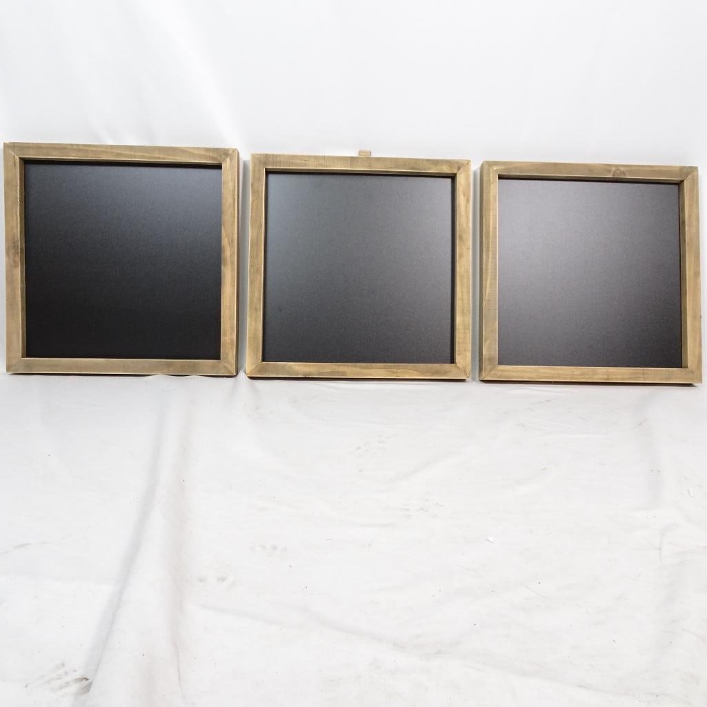 Set of 3 Wooden_Framed Chalkboards: A set of three brand_new chalkboards with natural wooden frames and matte black writing surfaces. Each board includes a metal hanger on the back for easy wall mounting, along with printed mounting ins