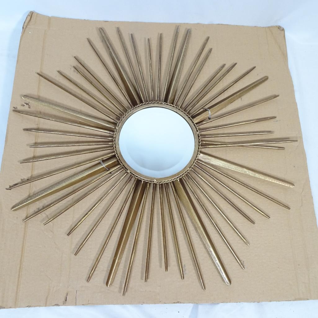 Large Gold Sunburst Wall Mirror: Striking gold sunburst wall mirror featuring a classic radiating metal frame design. This statement piece showcases layered gold-tone rays in varying lengths surrounding a round center mirror with dec