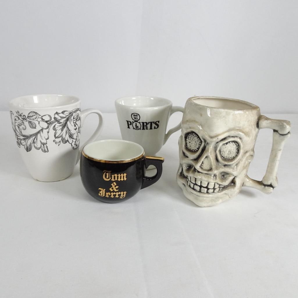 Mixed Coffee Mug Lot (4) - Skull Mug, Kon Tiki Ports, Tom and Jerry, Floral Cup: Lot of 4 assorted coffee mugs, featuring a unique mix of vintage and novelty styles. Condition: All mugs are pre-owned Show signs of use such as light staining, surface wear, and small imperfections N