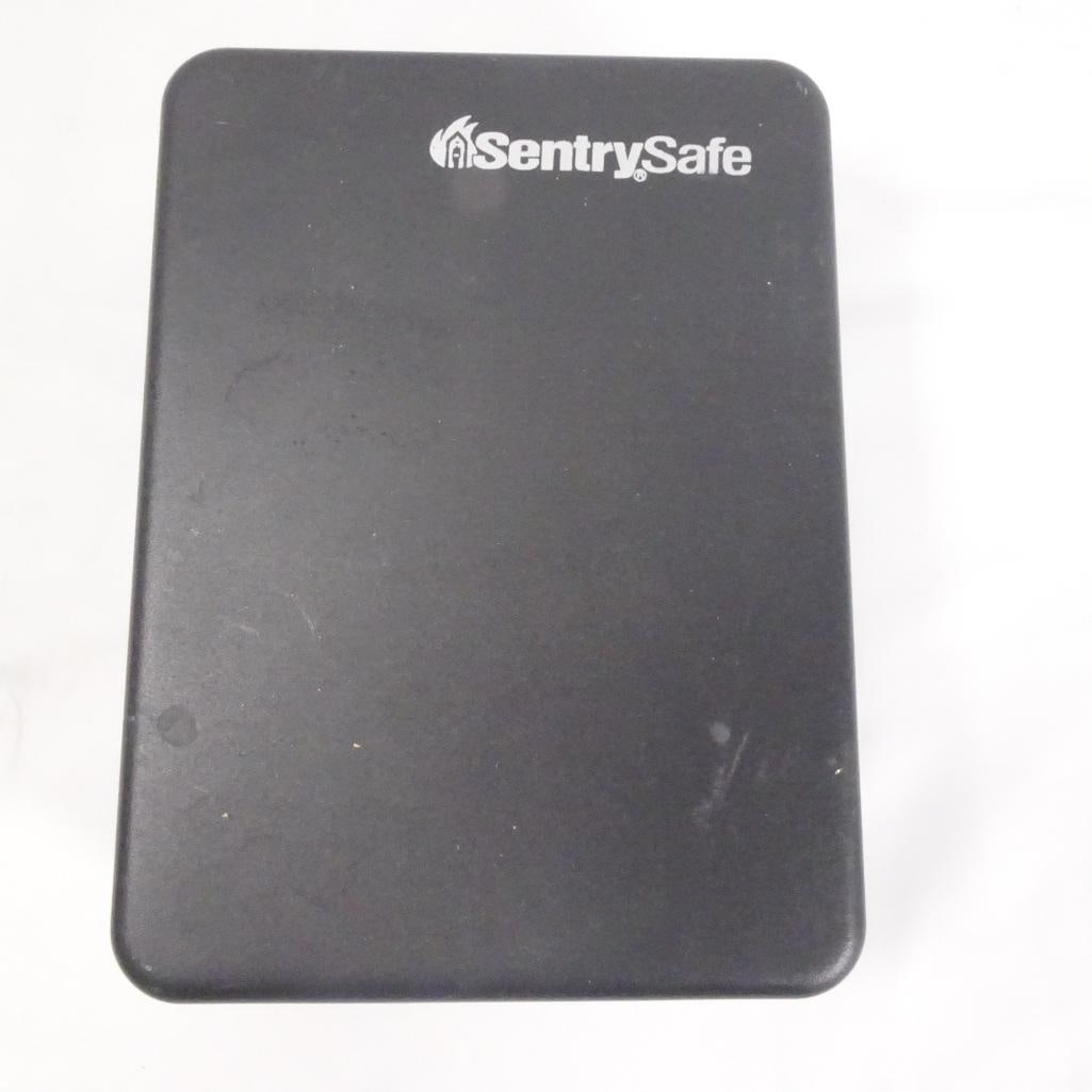 SentrySafe Fireproof Lock Box w/ Combination Lock - Portable Security Safe: SentrySafe portable lock box with combination lock, ideal for storing valuables and important documents. Condition: Pre-owned condition with visible signs of use such as light surface wear and marks. 