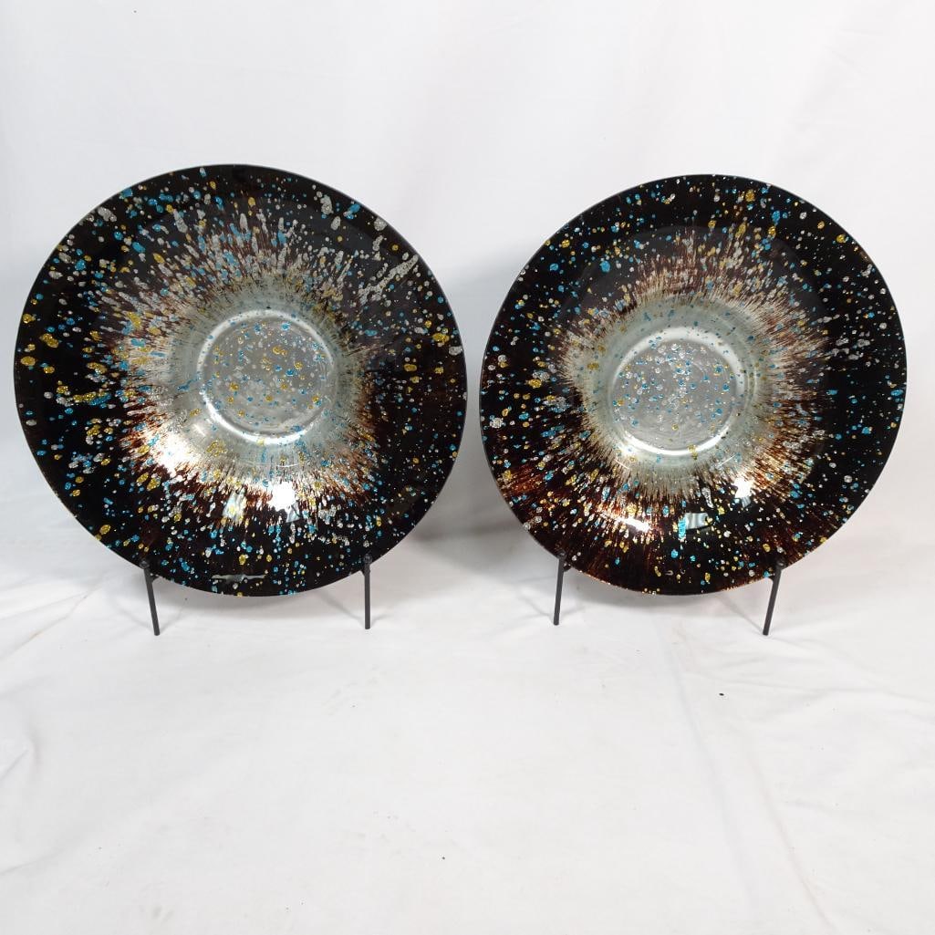 Pair Large Decorative Glass Charger Plates: Striking pair of large decorative glass charger plates featuring a beautiful cosmic splash / galaxy-style design with shimmering accents in gold, silver, and turquoise against a deep dark background. 