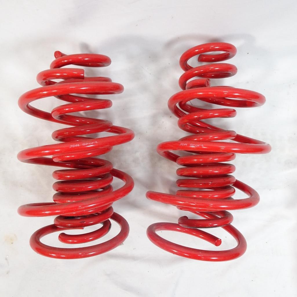 Pair of JDM Sport Red Lowering Suspension Springs: Pair of aftermarket JDM Sport suspension / lowering springs in red finish. These appear to be a used set of performance lowering springs removed from a vehicle. Branding on springs reads JDM Sport. Us
