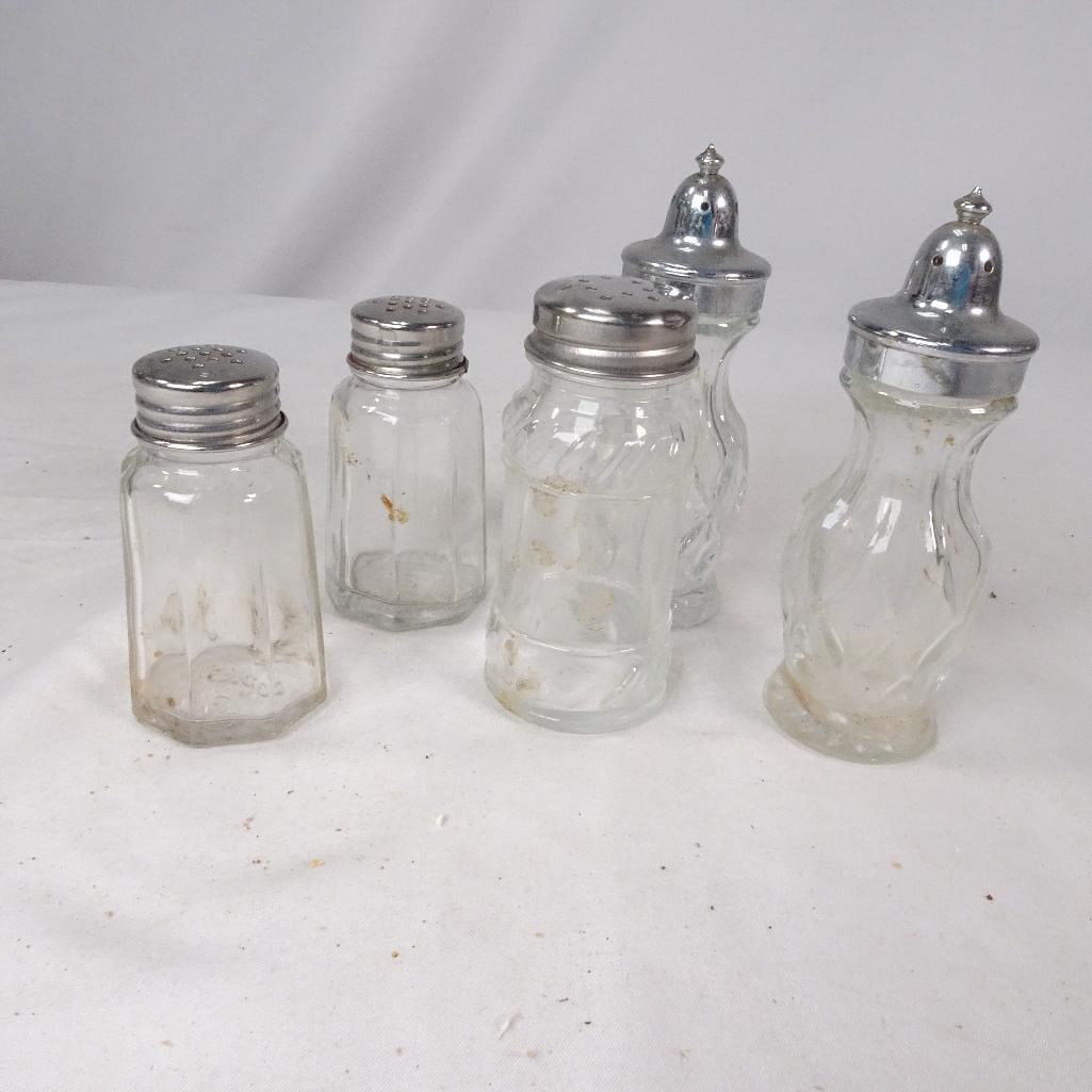Vintage Glass Salt and Pepper Shaker Lot: Mixed lot of vintage glass salt and pepper shakers featuring several retro styles with chrome-tone metal lids. Great for farmhouse kitchens, diner decor, restaurant collectibles, or vintage kitchenwar