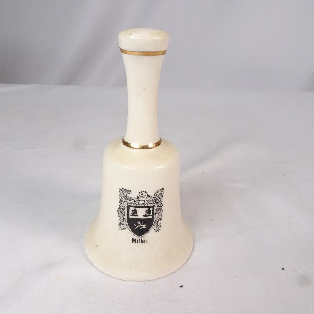 Vintage Miller Family Crest Porcelain Bell White Gold Trim Decorative Collectible: Vintage white porcelain bell featuring the Miller family crest / coat of arms design with elegant gold trim accents. A charming collectible piece perfect for family name collections, genealogy enthusi