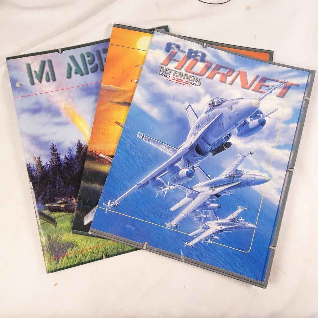 Defenders USA Military Folder Lot: Lot of 4 vintage Defenders USA educational presentation folders featuring iconic U.S. military aircraft and vehicles. Each folder includes full-color artwork on the front and informational reference p
