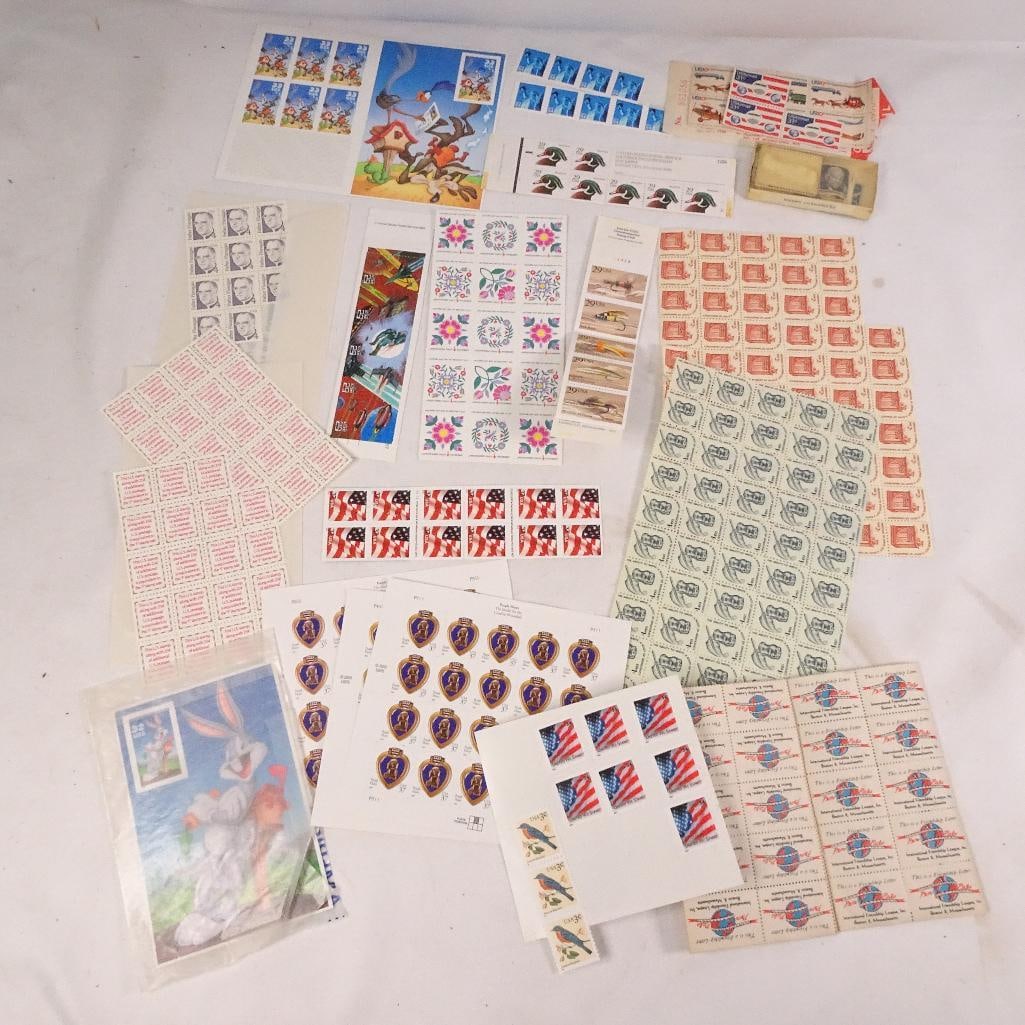 Vintage USPS Stamp Collection Lot: Large mixed lot of vintage U.S. postage stamps and commemorative issues. Includes a variety of unused stamp sheets, partial sheets, booklets, souvenir pages, patriotic themes, wildlife, military, cart