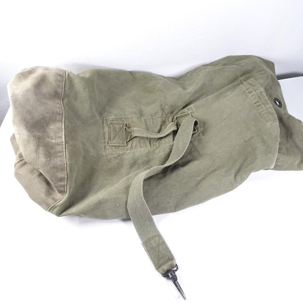 Vintage Military Canvas Sea Bag Duffel Bag Olive Drab Army Navy Gear Sack: Vintage military-style canvas sea bag / duffel bag in olive drab green. Constructed from heavy-duty canvas with reinforced carry strap and metal grommet closure. Ideal for military collectors, camping