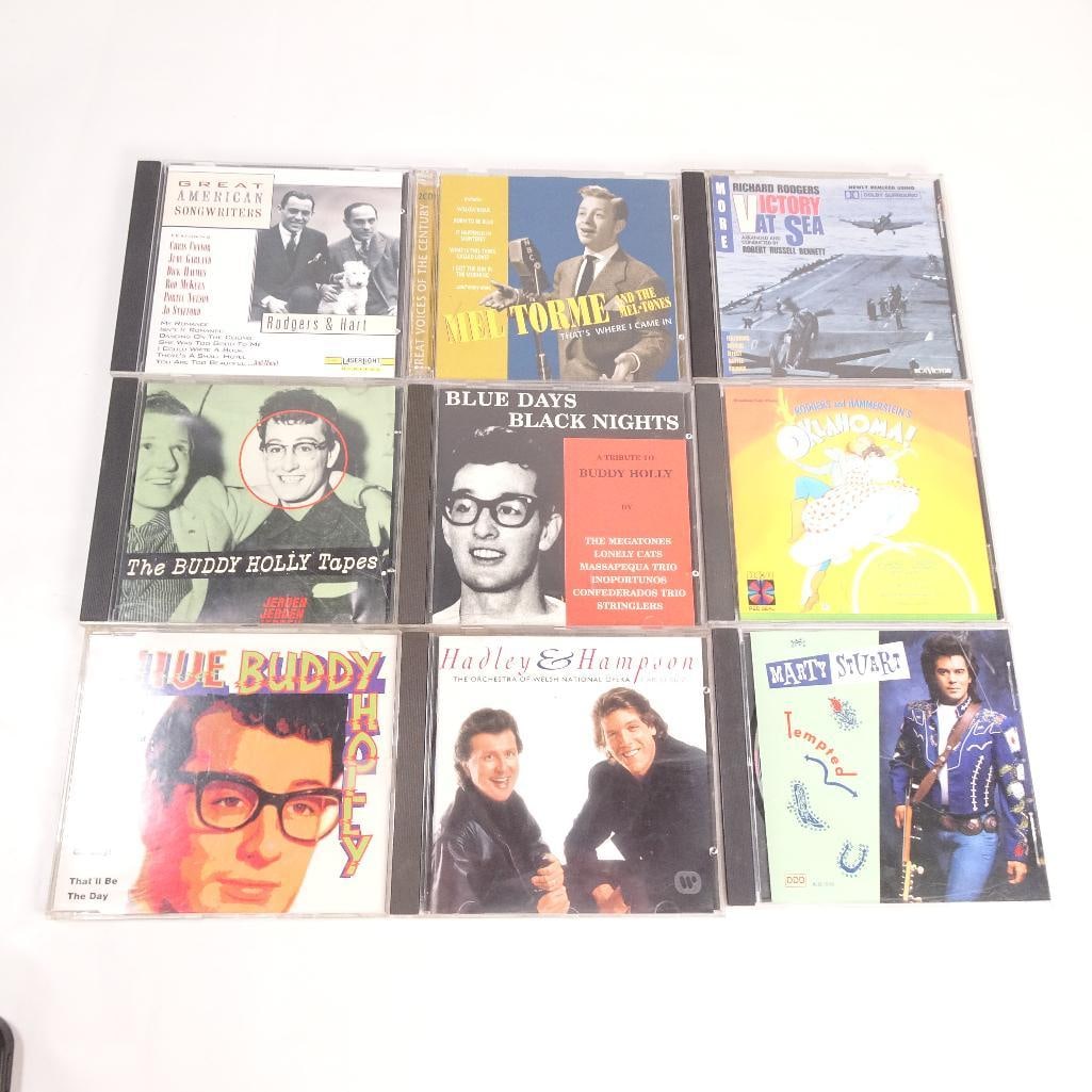 Lot of 9 CDs: Pre-owned lot of 9 music CDs featuring a mix of classic pop, rock and roll, Broadway, country, opera, and American standards. Sold as one lot.