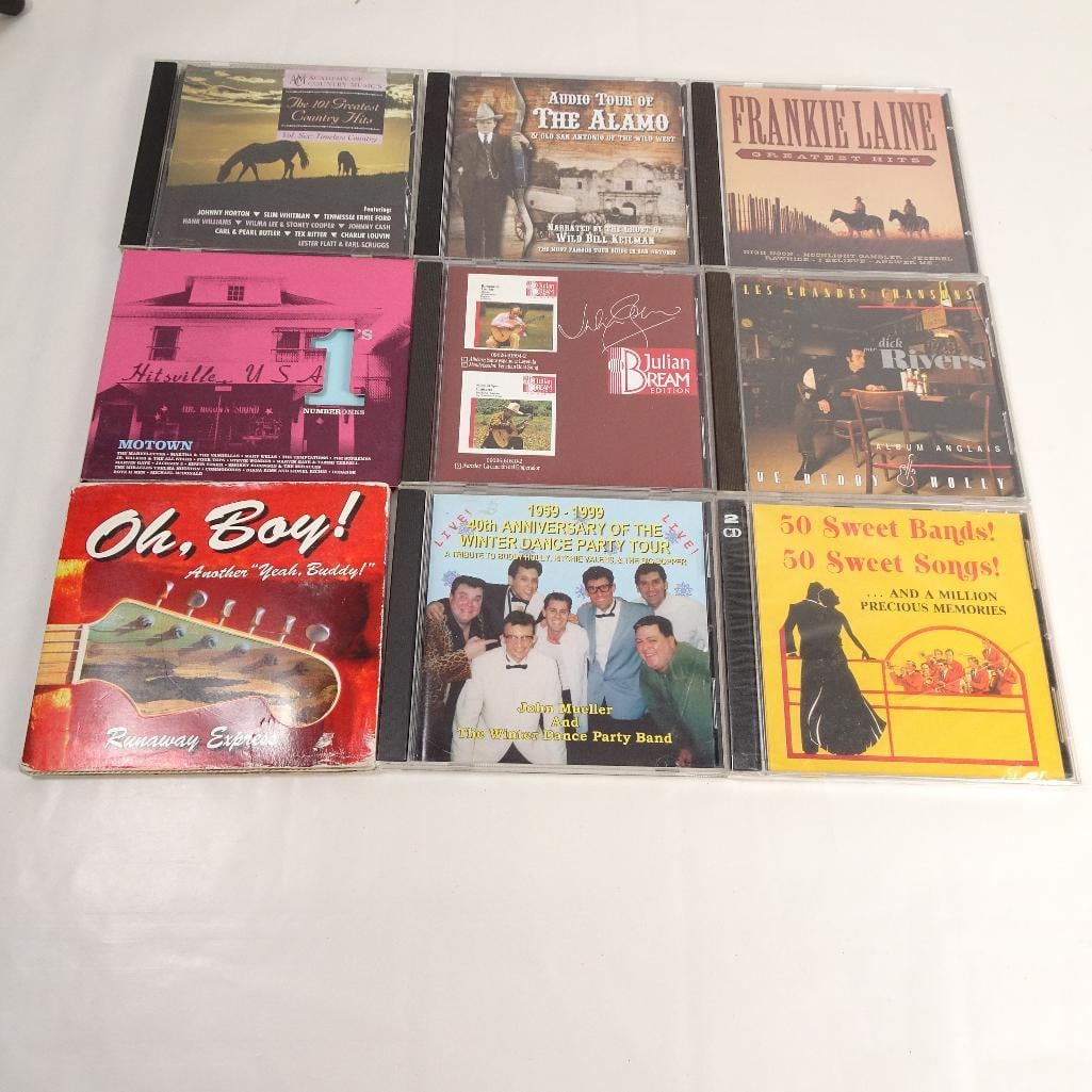 Lot of 9 Music CDs: Pre-owned lot of 9 music CDs featuring country, Motown, rock and roll, oldies, Buddy Holly tributes, and easy listening favorites. A fun collection for collectors and fans of classic American music. S