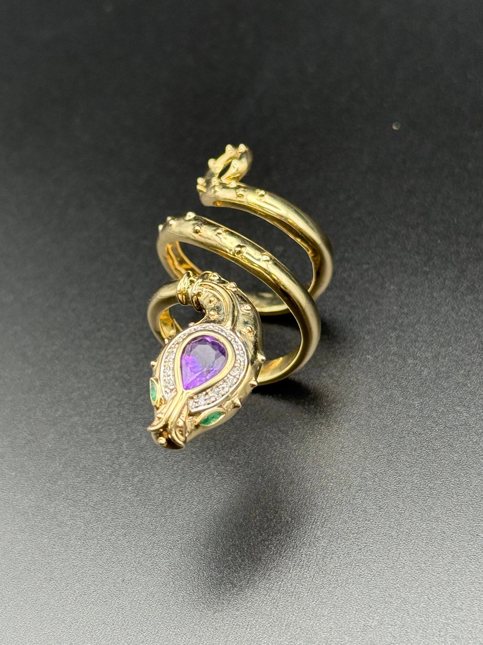 Spiral Snake Ring in 14k gold adjustable sizing ( 13.9 g ): Size 7 adjustable Snake ring in solid 14k 8mm x 5.25 with genuine teardrop amethyst 2 x 3.35 x1.5 genuine marquise Emeralds- 13x1.25mm Earth mined round diamonds
