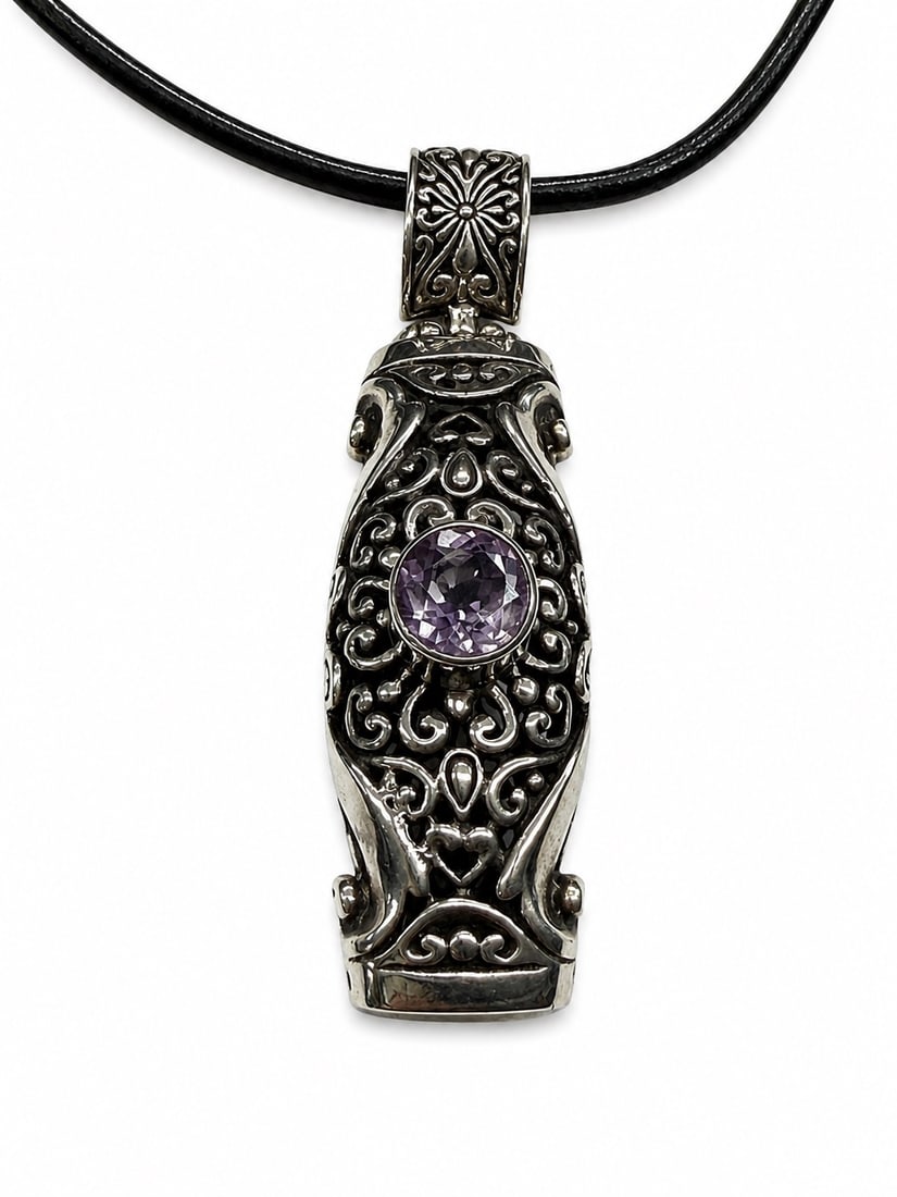 Sterling Silver Amethyst with lots of intricate carving Pendant Necklace: Sterling Silver(11.09 dwt) Amethyst Pendant on Black Leather Necklace with sterling silver tips. Beautiful open work on the backside as well with nice hinged bail.