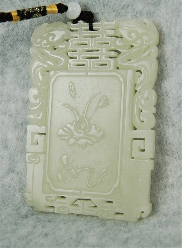Chinese Rectangular Jade Plaque: Chinese jade plaque, of rectangular shape and carved to the front with a reserve featuring five bats around a character roundel all framed by pierced tendrils and confronted mythical beasts, the rever