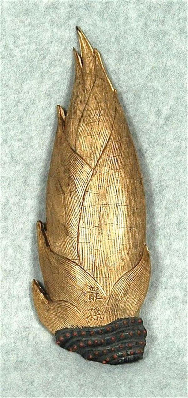 Chinese Gilt Bamboo Ink Stick: Chinese gilt decorated ink stick, molded as a gilt bamboo shoot with red-accented rhizome bands, one side with the inscription 'long sun' (dragon descendants), 9''h