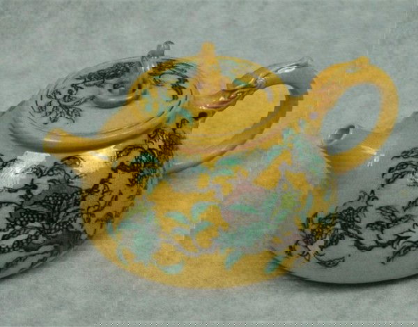 Chinese Yellow Glazed Porcelain Teapot: Chinese yellow glazed porcelain teapot, the sides sloping exteriors painted in a famille verte palette with fruit pomegranate trees on a rich yellow ground with a sgraffito dragon pattern, the short s