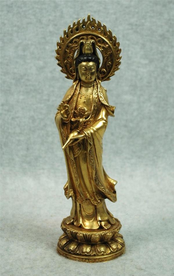 Chinese Gilt Bronze Figure of Guanyin: Chinese gilt bronze figure of Guanyin, the ¡®Goddess of Mercy¡¯ standing in brocade-trimmed robes and holding an amphora, the other hand raised in a gesture of fear-not (abhaya mudra), the aristoc
