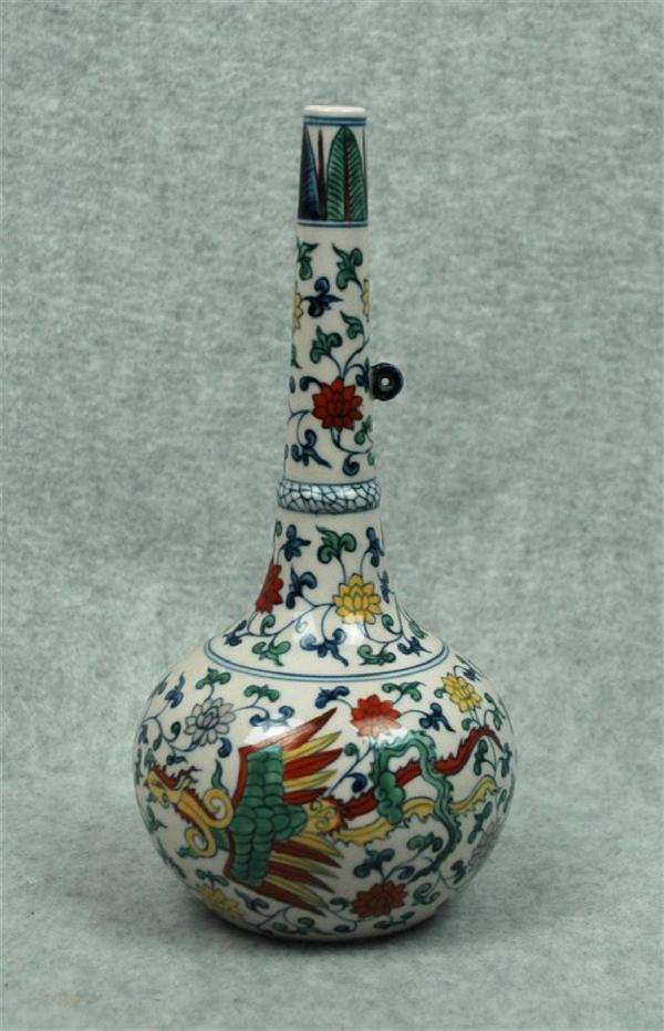 Chinese Dou-Cai Porcelain Vase: Chinese doucai porcelain stick-neck vase, the globular body decorated in underglaze blue and colored enamels with phoenix amid flowering leafy tendrils repeated on the tapering neck with a small circu