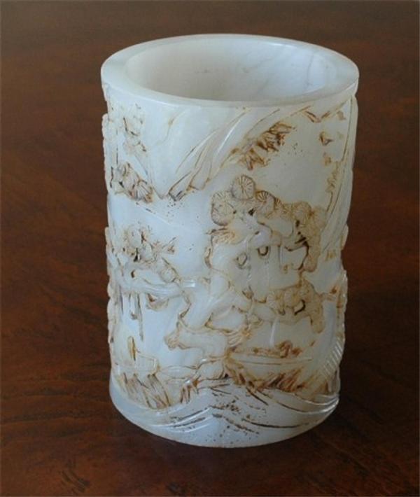 Chinese White Jade Brush Pot/Pen Holder: Chinese white jade brush pot/pen holder, the cylindrical exterior carved and incised with a continuous landscape with large pines and jagged cliffs, the details heighted with russet-brown pigment. 4.2