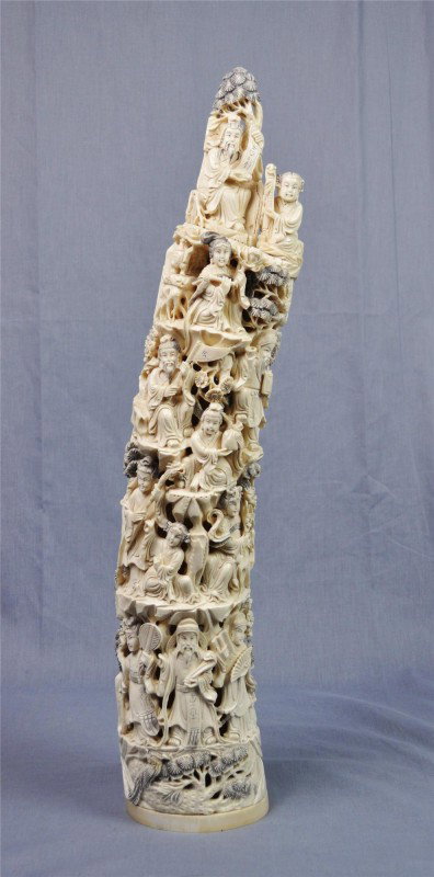 Chinese ivory tusk: Chinese ivory tusk, 20th century, finely carved and undercut with Chinese sages, beauties and numerous attendants engaged in various pursuits in a landscape setting, the details heightened with dark s