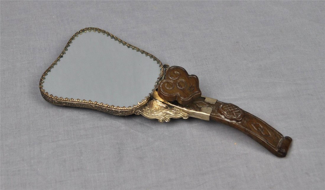 Chinese Decorative Hand Mirror: Chinese decorative hand mirror, decorated with antique jade stone as handle and dragons on silver lead back cover. 8.5" height.
