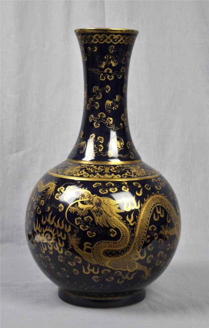 Chinese Dark Blue Glazed Porcelain Vase: Chinese dark blue glazed base with gold dragons and bats porcelain vase. 15.5" height.