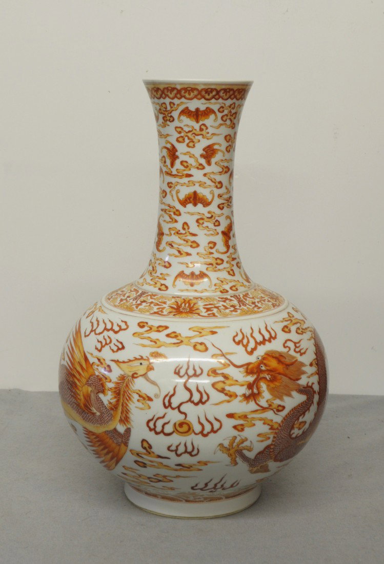 Large Chinese Iron Red with White Porcelain: Large Chinese iron red with white porcelain vase, decorated with dragon and phoenix around by bats and clouds. Six blue character under glaze mark on the base. 17.75" height.