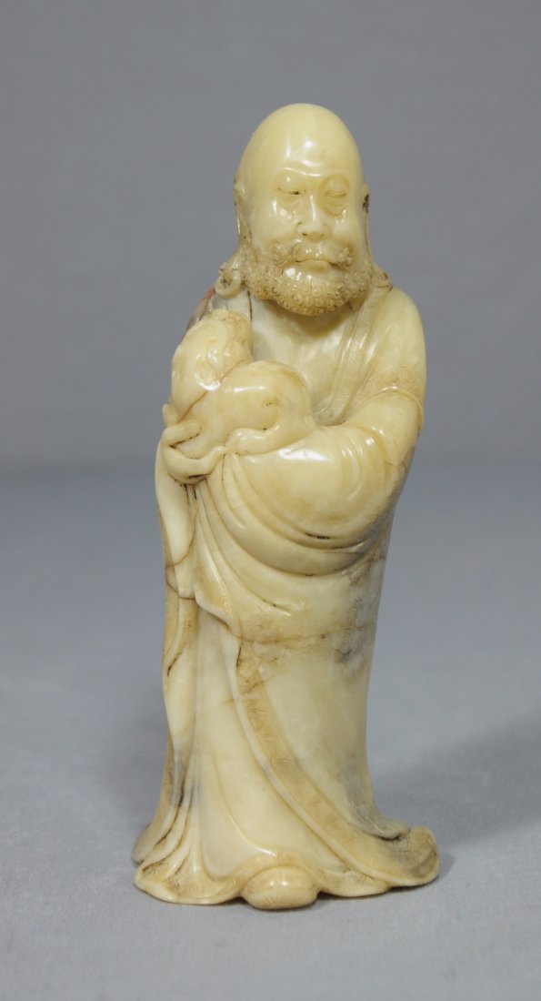 Nice Carved Chinese Shou-Shan Stone Figure: Nice carved Chinese Shou-Shan natural stone figure, decorated with louhan holding a dog. Early 20th century. Some natural stone line. Good condition. 5.5" height .